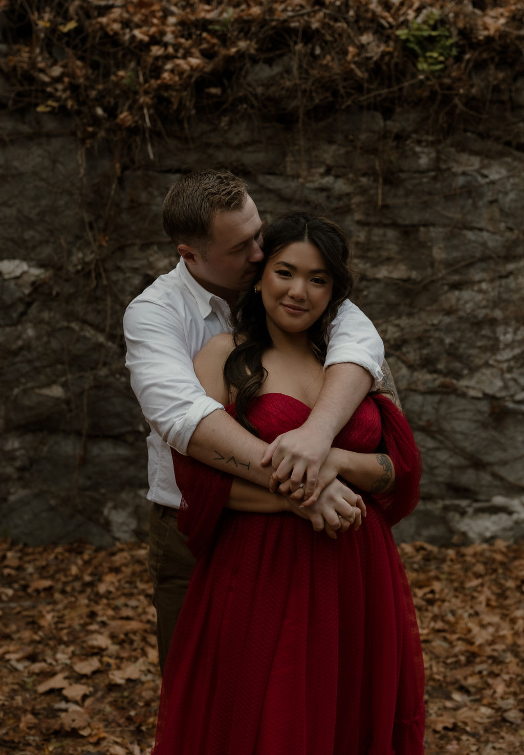 a man hugging his fiance captured by a Massachusetts Engagement Photographer