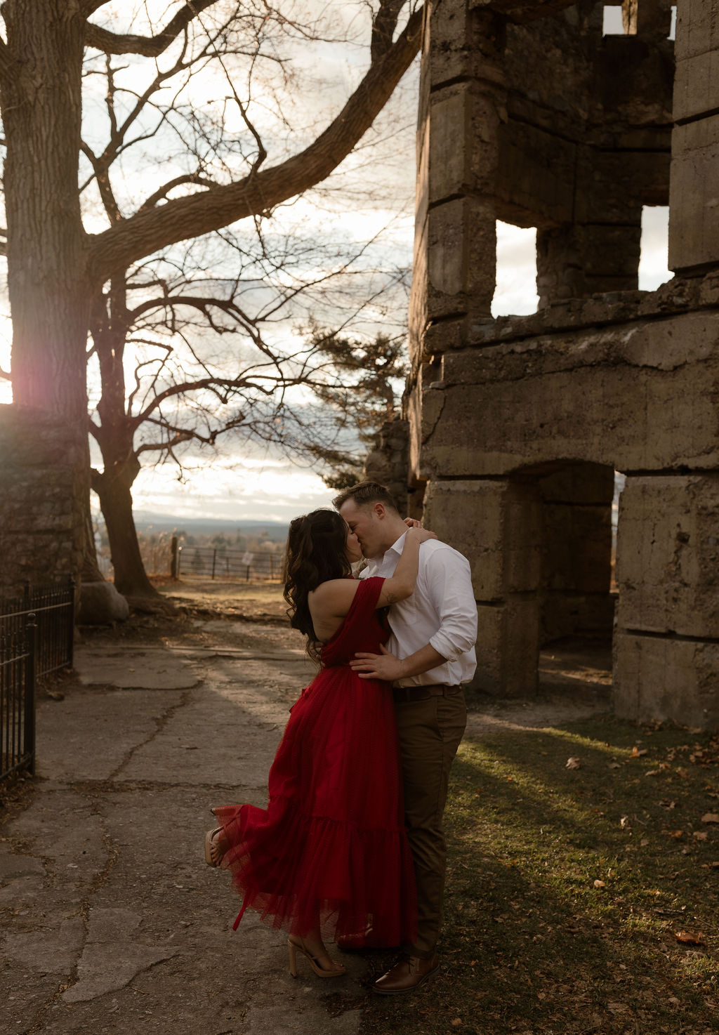 a couple kissing by a castle for their Massachusetts Engagement Photos