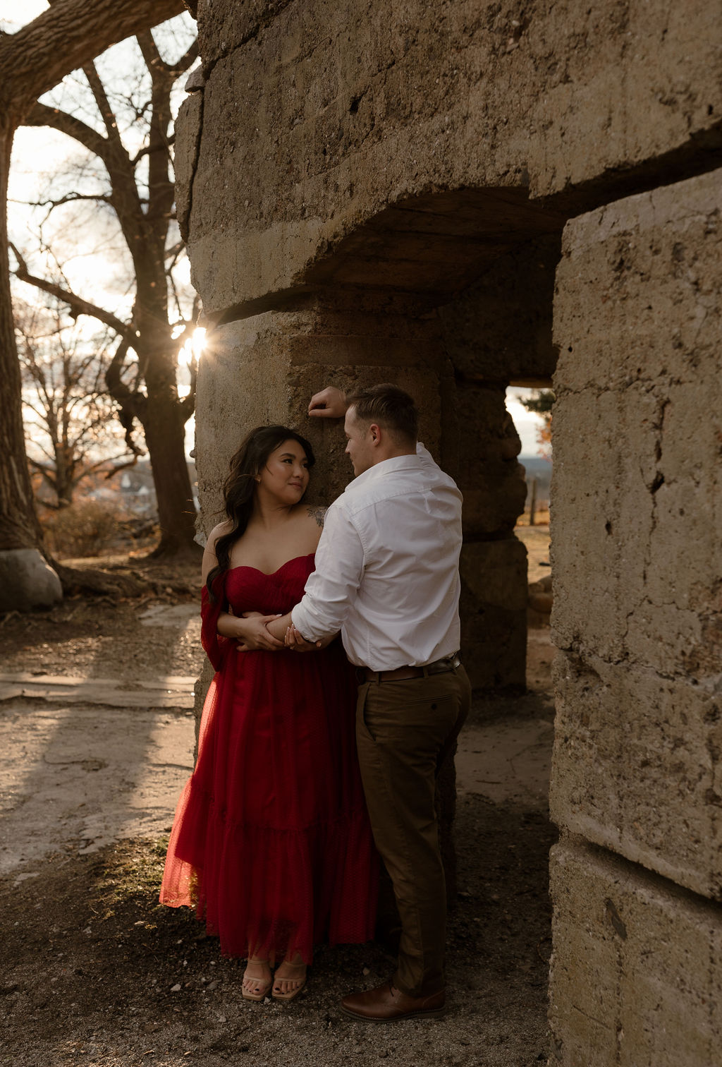 newly engaged couple standing against a castle captured by a Massachusetts Engagement Photographer