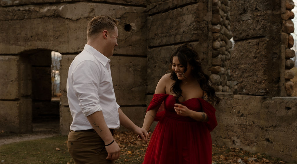 candid engagement photo of the couple laughing together 