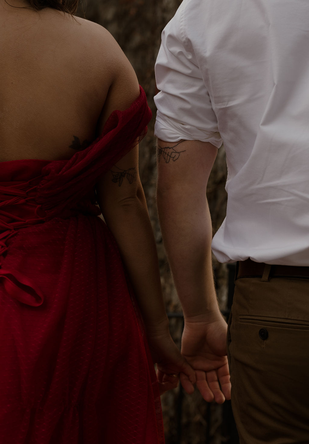 newly engaged couple with their matching tattoos 