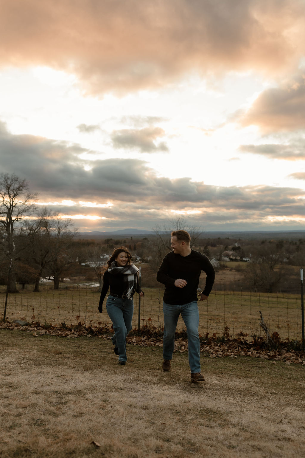 a couple running around on the hills in Massachusetts 