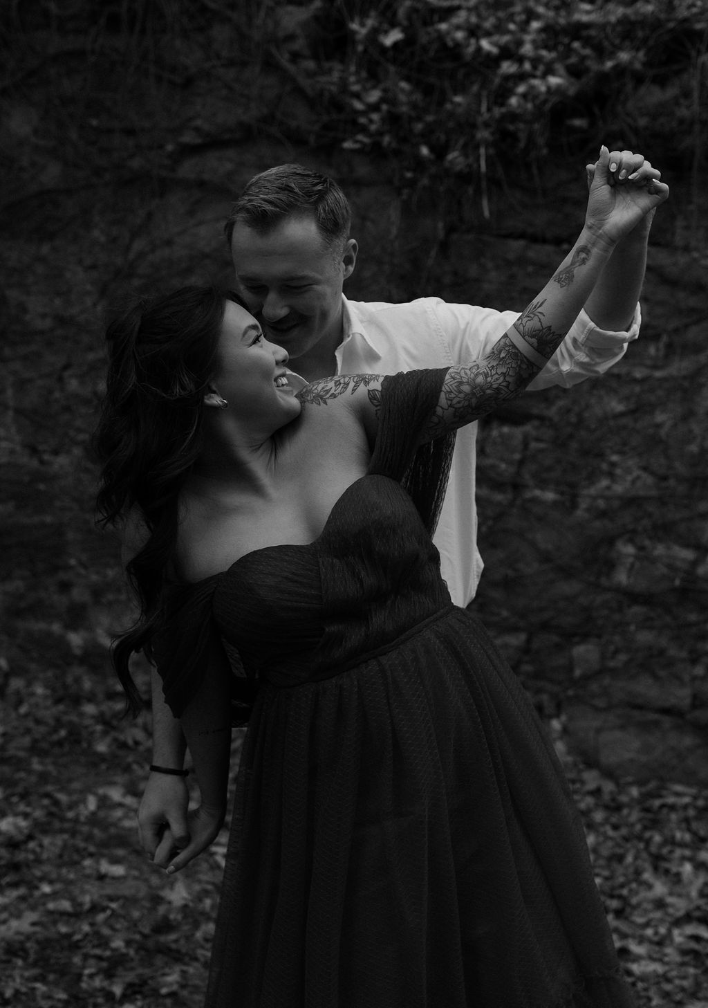 documentary style engagement photo of a couple dancing 