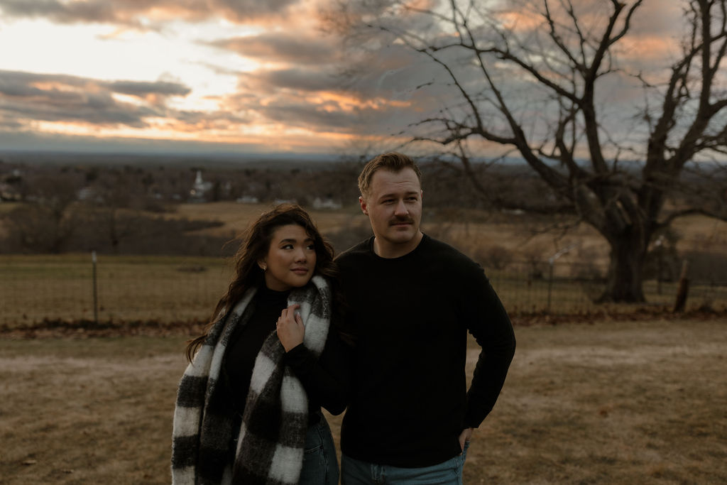 man and woman posing for their outdoor engagement photos 