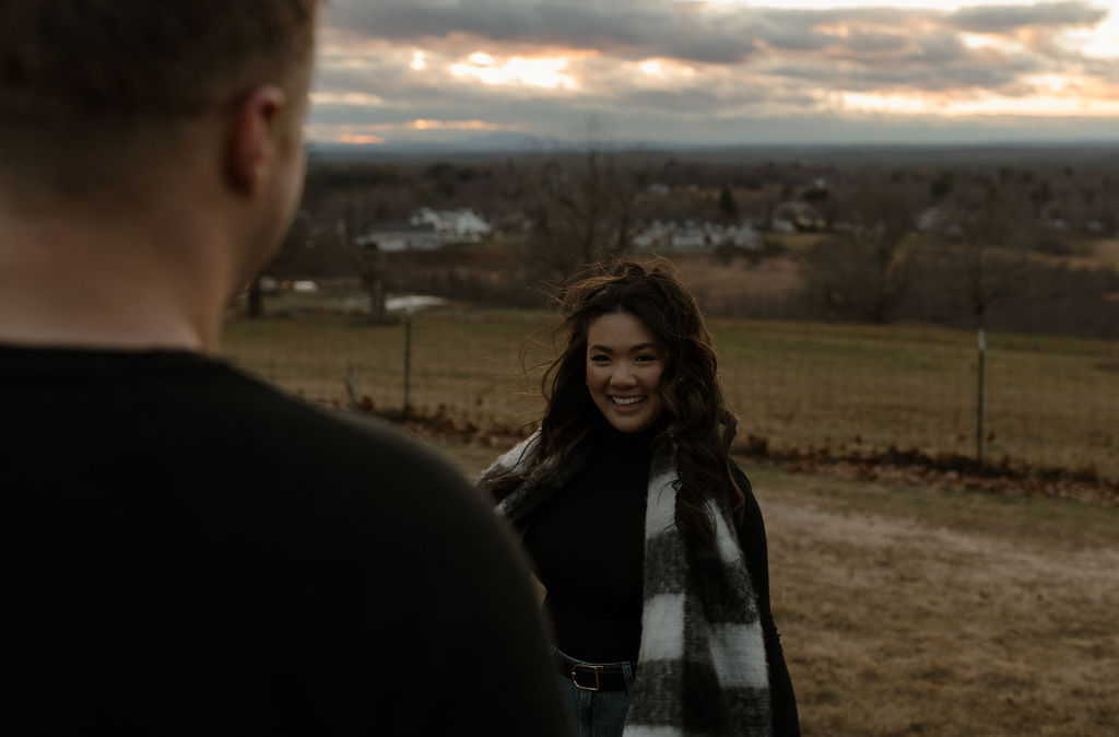 a woman smiling and looking at her fiance