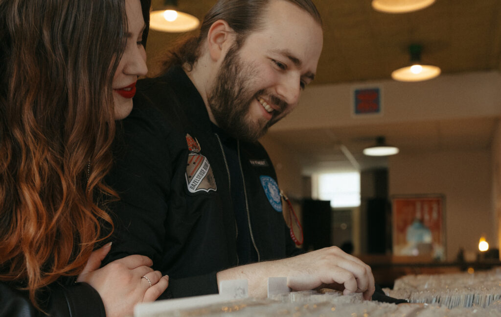 newly engaged couple picking out music at record store