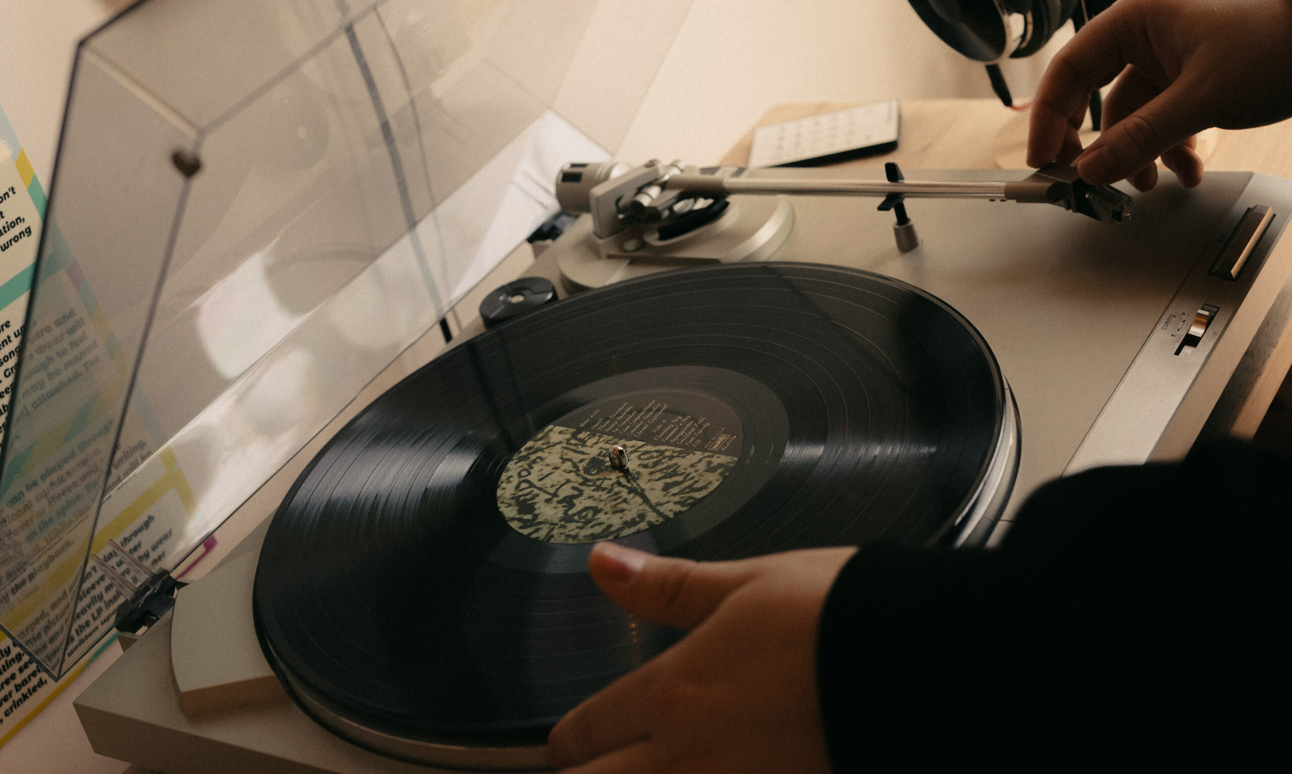 couple playing record in record store